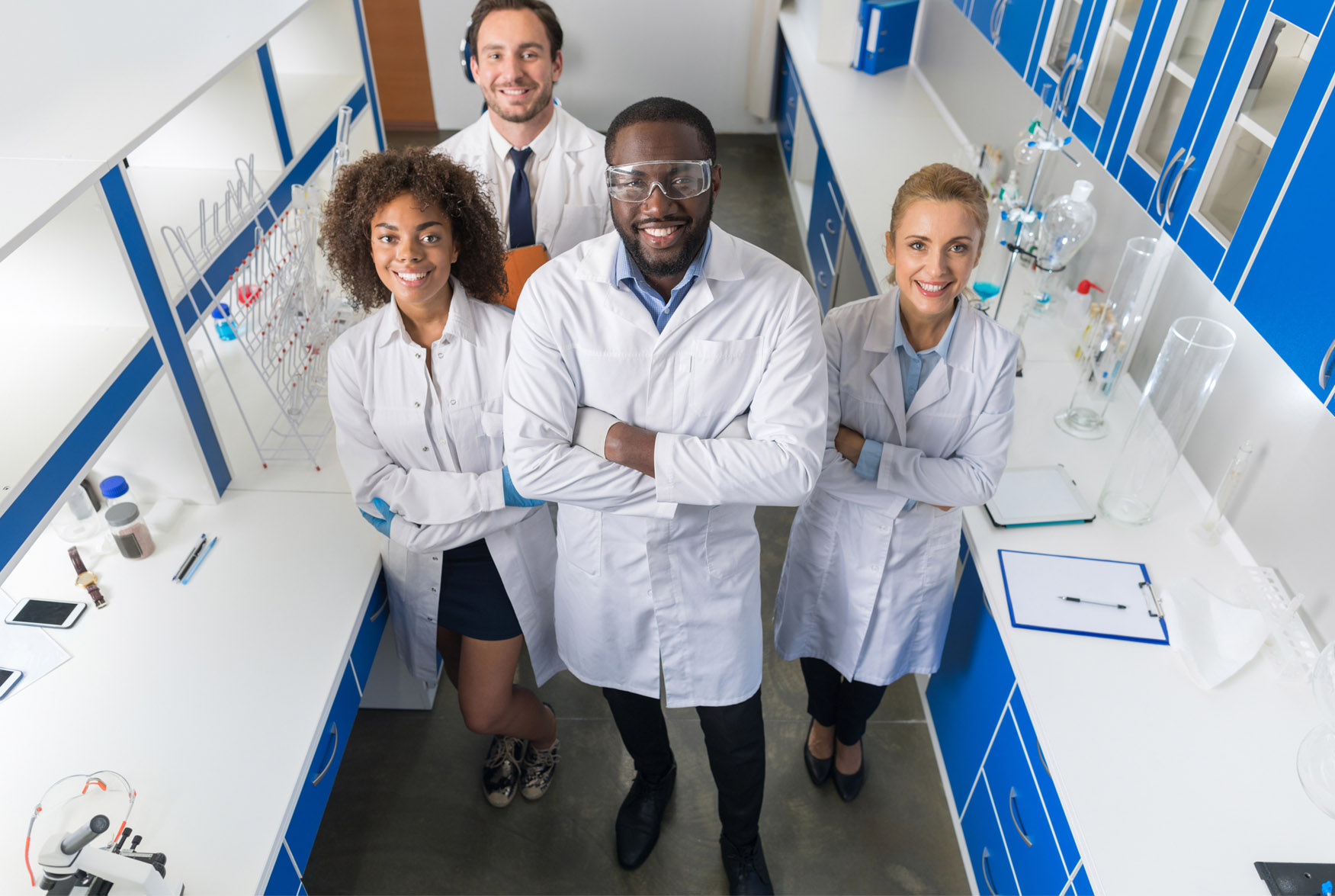 Smiling senior scientist with her colleagues in laboratory Smiling senior scientist with her colleagues in laboratory